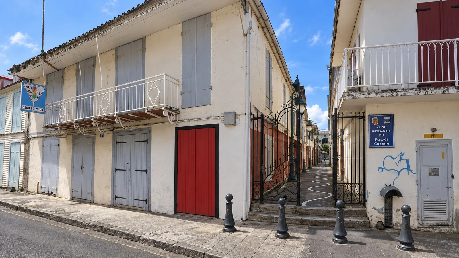 L'angle du bâtiment avant projet : façade décrépie, volets gris, balcon de ferronnerie et entrée du passage Cicéron.